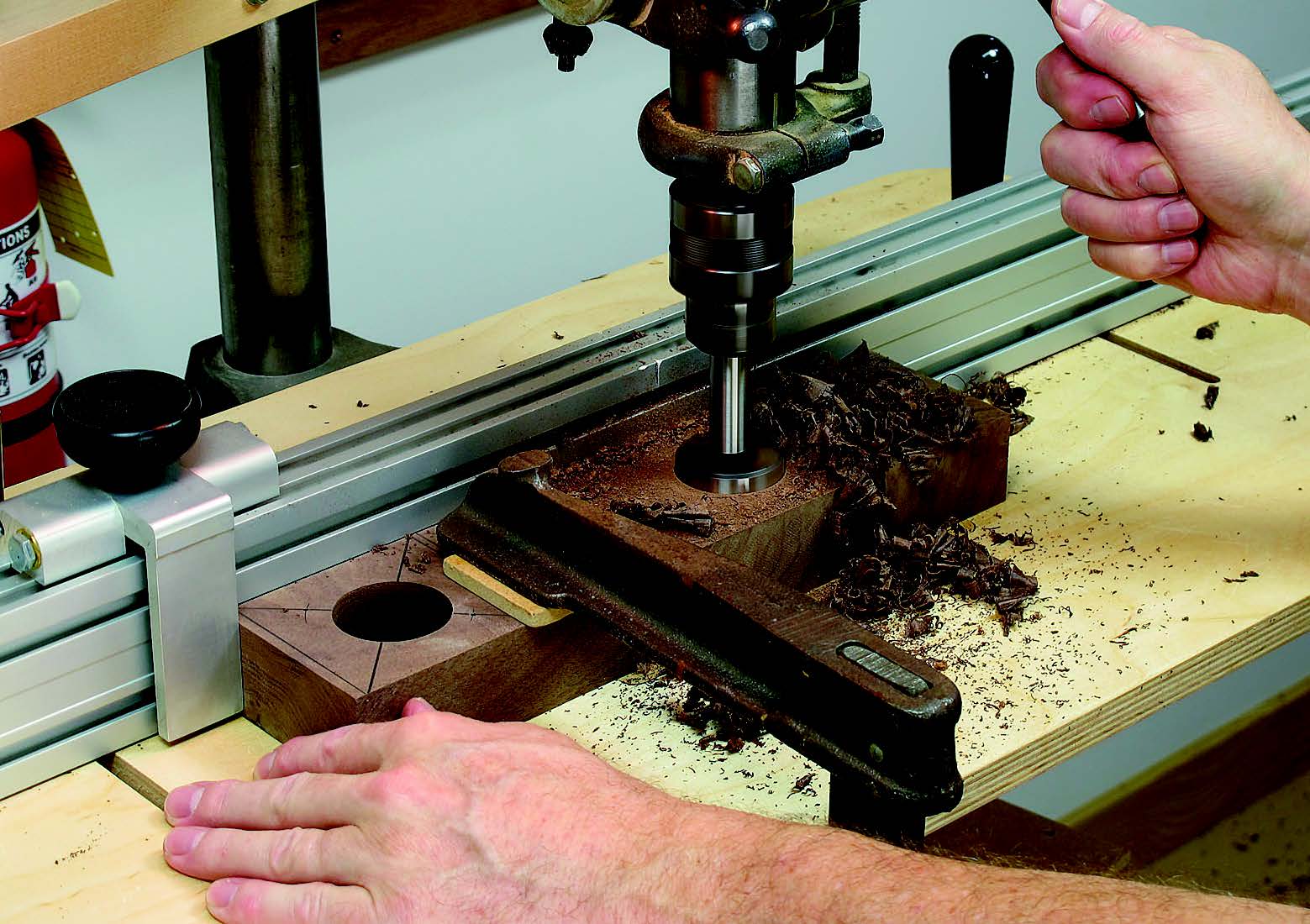Drill the 15⁄8”-diameter x 11⁄4”-deep center holes in the base stock. Clamp the workpiece tightly to the drill press table; otherwise, the bit may wander off center.