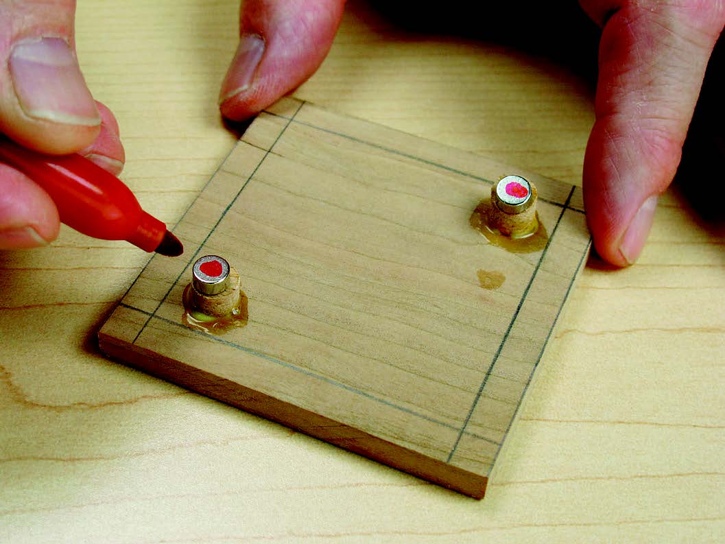 Determine the base magnets’ orientation. Set them on top of the lid plugs, mark the tops, then insert the magnets in the base with the marks down.