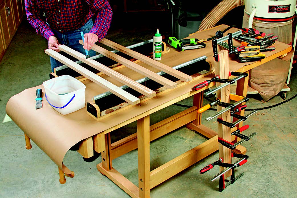 Riftsawn laminations of white oak form legs with an even grain pattern all around. Only a keen eye will see the glue line. A brad nail driven into the waste ends of each leg can keep slippery glue joints aligned for clamping.