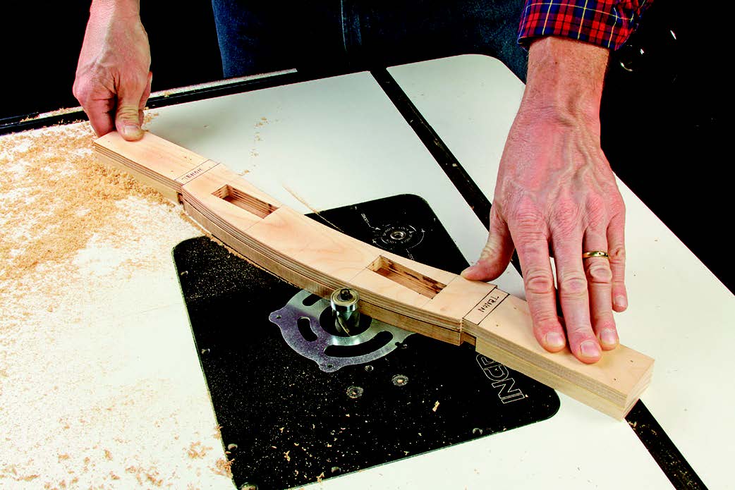 Use the templates to draw curves on the aprons and rails. Rough-cut them about 1/16" outside the layout lines, then tape them beneath the templates.